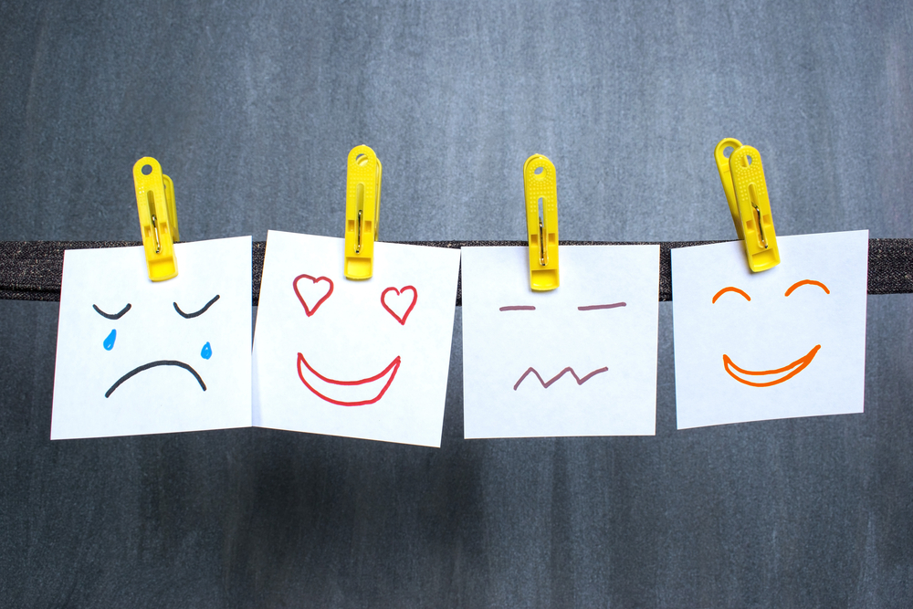 Different emotions drawn on notes, dark background.